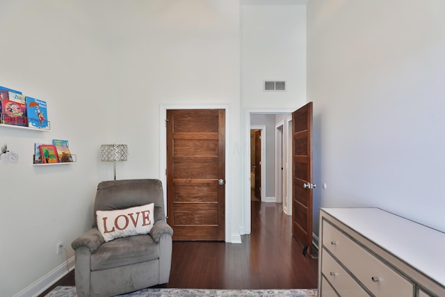 258 Canyon Dr, Columbus, OH 43214 - sitting room with dark wood-style floors, a towering ceiling, and baseboards