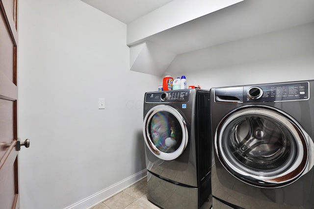 258 Canyon Dr, Columbus, OH 43214 - laundry room featuring washing machine and clothes dryer, light tile patterned floors, and baseboards