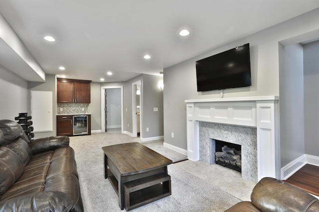 258 Canyon Dr, Columbus, OH 43214 - living area with beverage cooler, a high end fireplace, recessed lighting, baseboards, and bar