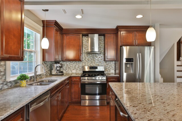 258 Canyon Dr, Columbus, OH 43214 - kitchen featuring stainless steel appliances, wall chimney exhaust hood, a sink, dark wood-type flooring, and light stone countertops
