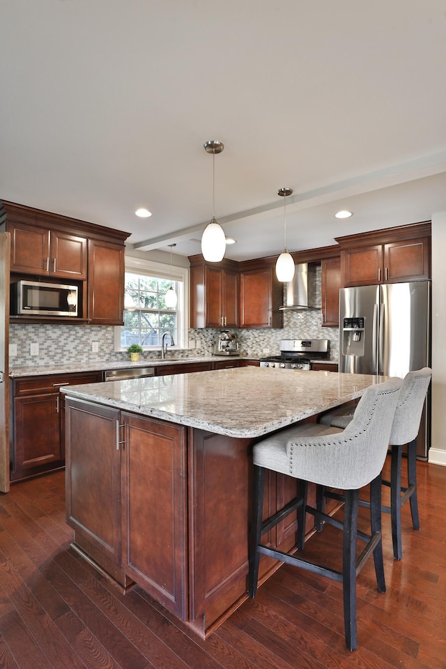 258 Canyon Dr, Columbus, OH 43214 - kitchen featuring wall chimney range hood, stainless steel appliances, a kitchen island, dark wood finished floors, and tasteful backsplash