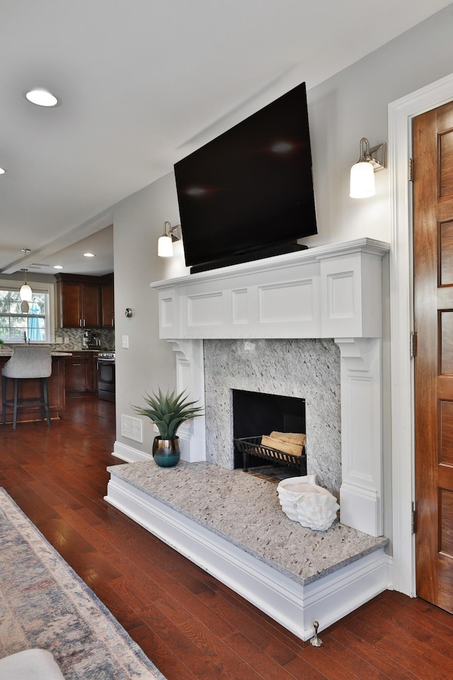 258 Canyon Dr, Columbus, OH 43214 - detailed view of wood finished floors, recessed lighting, a premium fireplace, and decorative backsplash