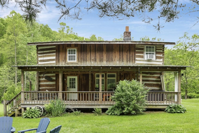 23587 Woltz Rd, Rockbridge, OH 43149 - rear view of house with a chimney, log siding, a lawn, and a wooden deck