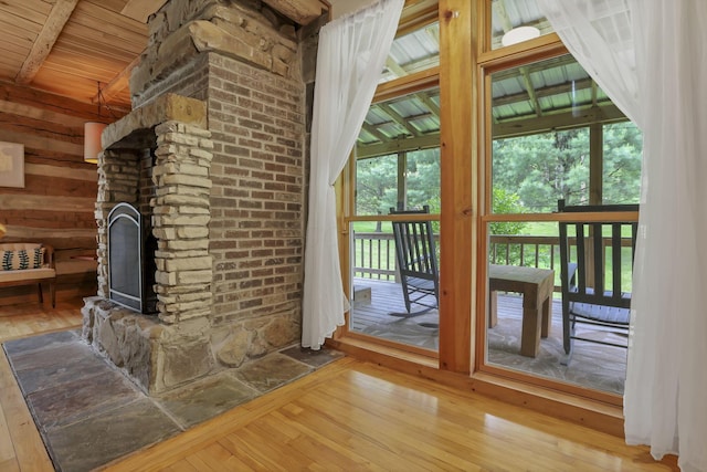 23587 Woltz Rd, Rockbridge, OH 43149 - unfurnished living room featuring hardwood / wood-style floors, vaulted ceiling, a fireplace, and wooden ceiling