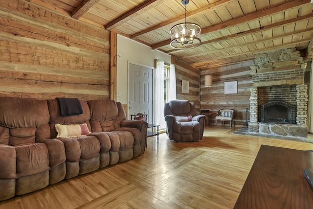 23587 Woltz Rd, Rockbridge, OH 43149 - living room featuring wooden walls, a chandelier, wooden ceiling with exposed beams, and a large fireplace