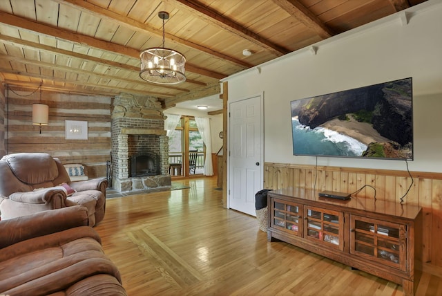 23587 Woltz Rd, Rockbridge, OH 43149 - living area featuring wood ceiling with exposed beams, wooden walls, light wood-style floors, a chandelier, and a fireplace