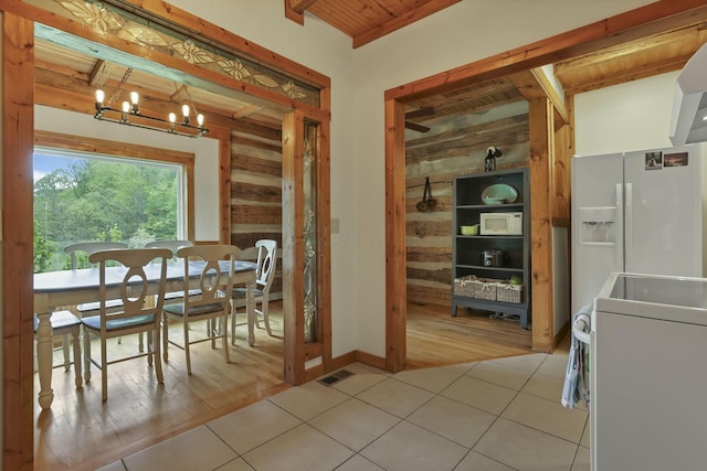 23587 Woltz Rd, Rockbridge, OH 43149 - dining room with washer / dryer, wood walls, light tile patterned flooring, a chandelier, and wood ceiling