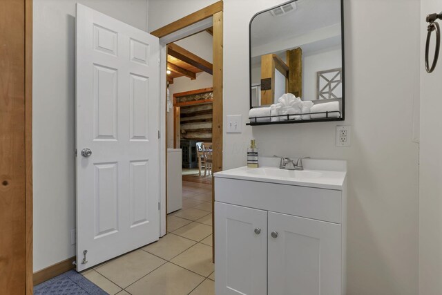 23587 Woltz Rd, Rockbridge, OH 43149 - bathroom featuring tile patterned floors, beam ceiling, vanity, and baseboards