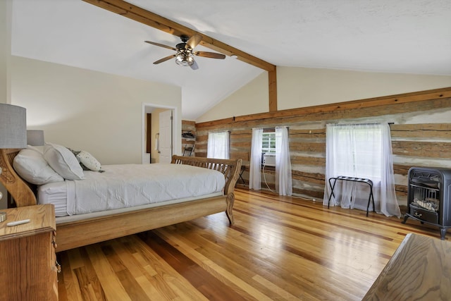 23587 Woltz Rd, Rockbridge, OH 43149 - bedroom featuring heating unit, a wood stove, wood finished floors, and ceiling fan