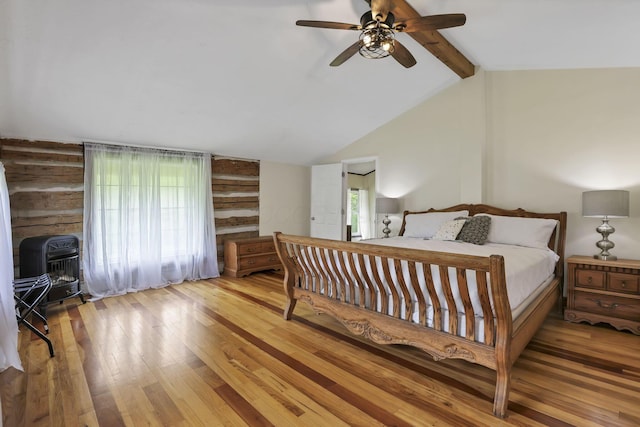 23587 Woltz Rd, Rockbridge, OH 43149 - bedroom with hardwood / wood-style floors, wooden walls, ceiling fan, and heating unit