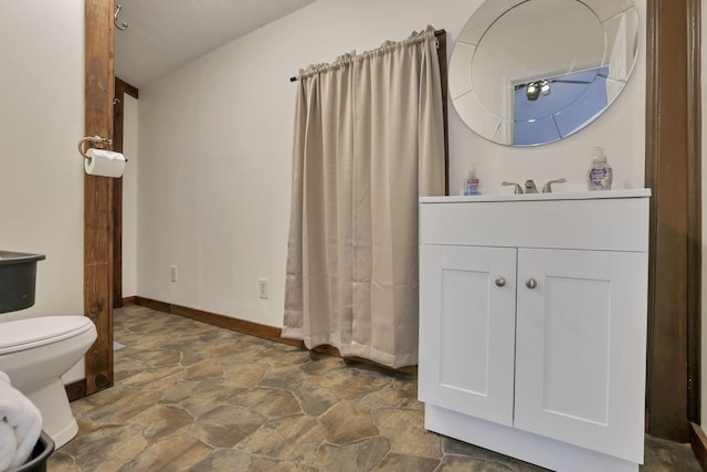 23587 Woltz Rd, Rockbridge, OH 43149 - bathroom featuring stone flooring, vanity, toilet, and baseboards