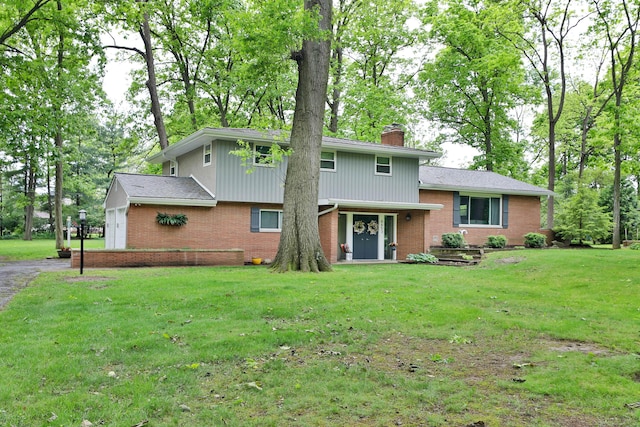 6653 Merwin Rd, Columbus, OH 43235 - view of front of house with brick siding, a chimney, and a front lawn
