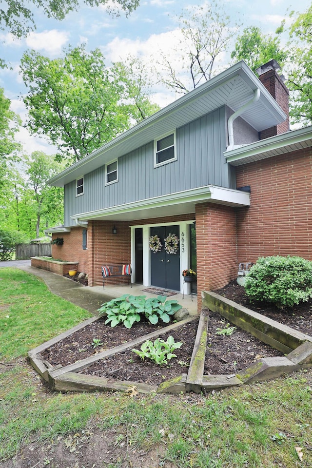 6653 Merwin Rd, Columbus, OH 43235 - back of property featuring brick siding and a chimney