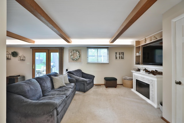 6653 Merwin Rd, Columbus, OH 43235 - carpeted living area with healthy amount of natural light, a fireplace, beamed ceiling, and baseboards