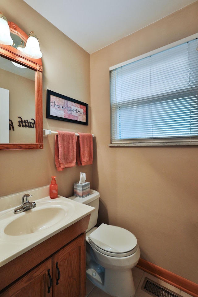 6653 Merwin Rd, Columbus, OH 43235 - bathroom with toilet, vanity, tile patterned flooring, and baseboards