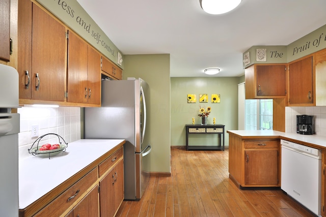 6653 Merwin Rd, Columbus, OH 43235 - kitchen featuring dishwasher, freestanding refrigerator, light countertops, tasteful backsplash, and brown cabinetry