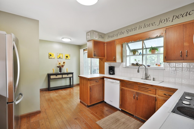 6653 Merwin Rd, Columbus, OH 43235 - kitchen with freestanding refrigerator, white dishwasher, black electric stovetop, a sink, and light countertops