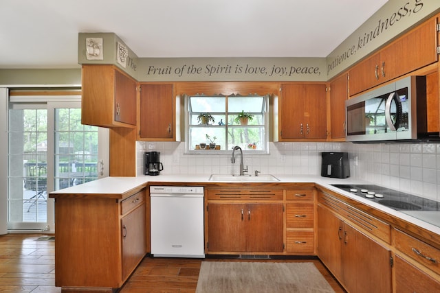 6653 Merwin Rd, Columbus, OH 43235 - kitchen featuring dishwasher, a sink, stainless steel microwave, black electric cooktop, and a peninsula