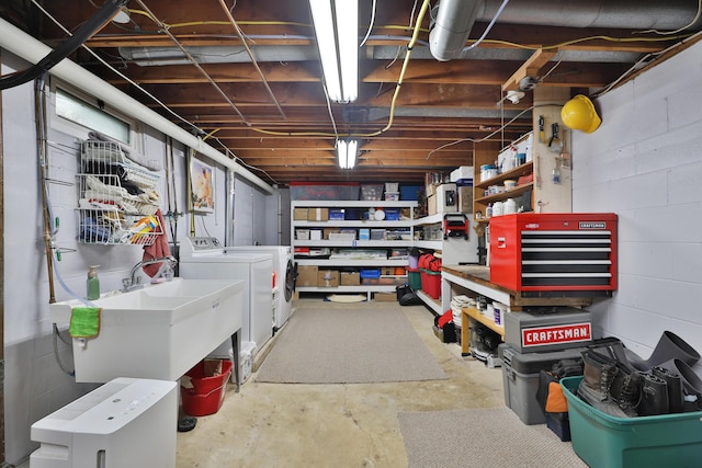 6653 Merwin Rd, Columbus, OH 43235 - unfinished basement featuring washer and clothes dryer, a sink, concrete block wall, and a workshop area
