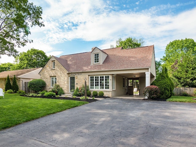2356 Swansea Rd, Columbus, OH 43221 - new england style home featuring stone siding, asphalt driveway, a shingled roof, and a carport