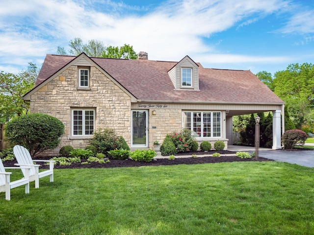 2356 Swansea Rd, Columbus, OH 43221 - view of front of house featuring stone siding, a chimney, a front yard, a shingled roof, and driveway