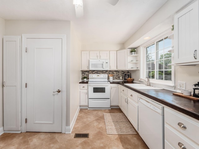 2356 Swansea Rd, Columbus, OH 43221 - kitchen featuring white appliances, a sink, dark countertops, open shelves, and white cabinets