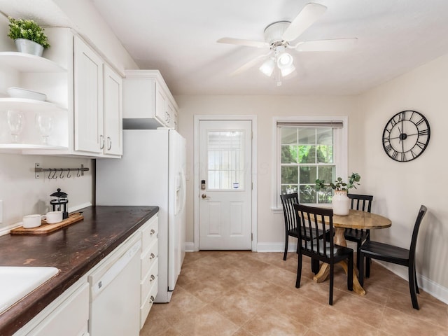 2356 Swansea Rd, Columbus, OH 43221 - kitchen featuring white appliances, dark countertops, white cabinets, a ceiling fan, and baseboards