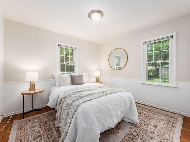 2356 Swansea Rd, Columbus, OH 43221 - bedroom with multiple windows, wood finished floors, and baseboards