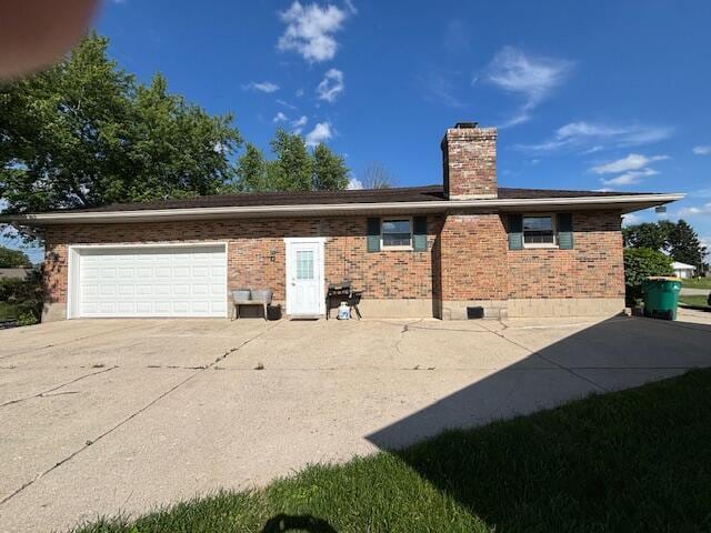 4367 Helena Ct, Springfield, OH 45503 - view of home's exterior featuring brick siding, concrete driveway, a chimney, and a garage