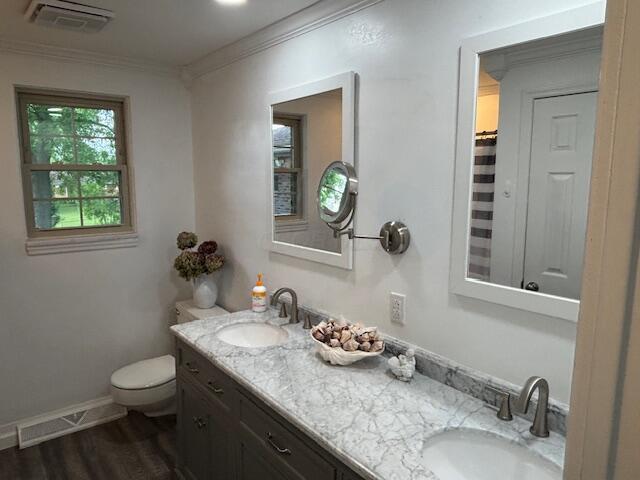 4367 Helena Ct, Springfield, OH 45503 - bathroom with toilet, crown molding, double vanity, wood finished floors, and a shower with curtain