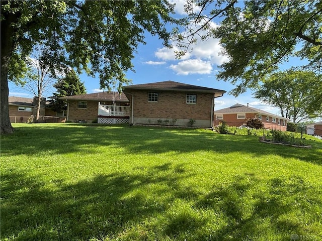 4367 Helena Ct, Springfield, OH 45503 - rear view of property with brick siding, a lawn, and a wooden deck