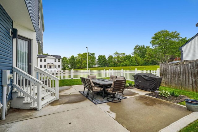 1536 Mulligan Ct, Reynoldsburg, OH 43068 - fenced backyard with a patio, outdoor dining space, and view of wooded area