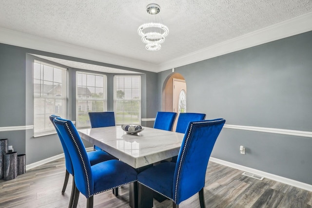 1536 Mulligan Ct, Reynoldsburg, OH 43068 - dining area with a textured ceiling, a chandelier, wood finished floors, arched walkways, and baseboards