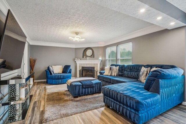 1536 Mulligan Ct, Reynoldsburg, OH 43068 - living room featuring a textured ceiling, wood finished floors, ornamental molding, a fireplace, and baseboards