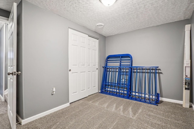 1536 Mulligan Ct, Reynoldsburg, OH 43068 - unfurnished bedroom with carpet flooring, a textured ceiling, a closet, and baseboards