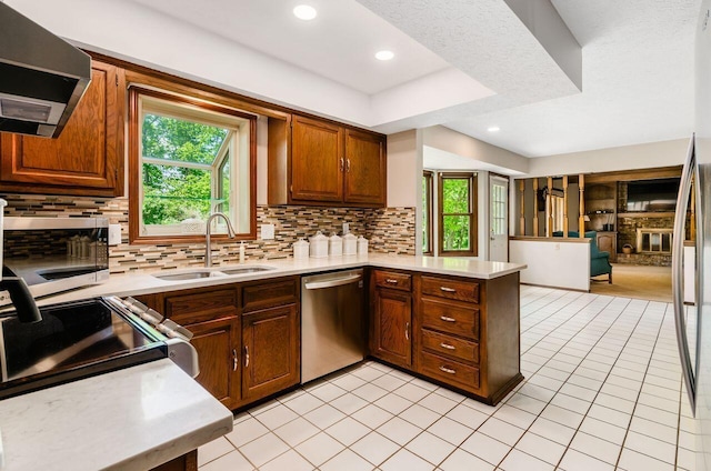 665 Northbridge Ct, Westerville, OH 43081 - kitchen featuring appliances with stainless steel finishes, a sink, a peninsula, light countertops, and exhaust hood