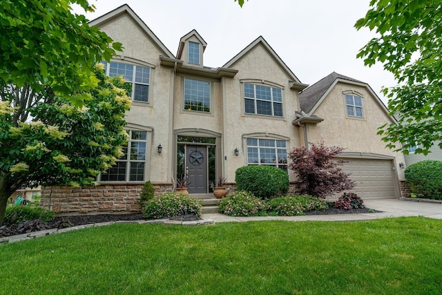 8738 Birch Brook Loop NW, Pickerington, OH 43147 - view of front of property with concrete driveway, stucco siding, a front yard, and an attached garage