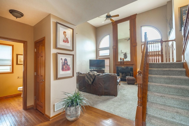 8738 Birch Brook Loop NW, Pickerington, OH 43147 - living area with hardwood / wood-style floors, stairway, baseboards, a ceiling fan, and lofted ceiling