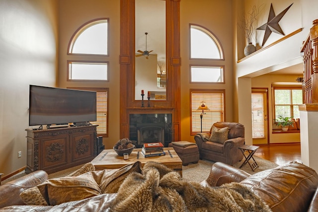 8738 Birch Brook Loop NW, Pickerington, OH 43147 - living room featuring a towering ceiling, ceiling fan, wood finished floors, and a fireplace