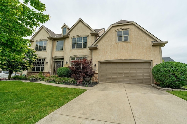 8738 Birch Brook Loop NW, Pickerington, OH 43147 - view of front facade featuring stucco siding, a front yard, driveway, and an attached garage