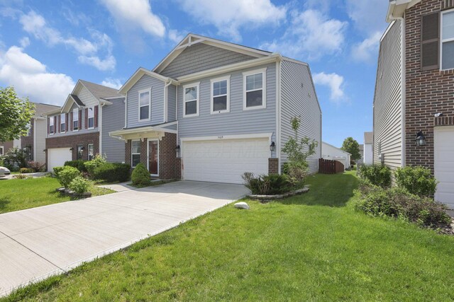 7429 Willow Leaf Dr, Canal Winchester, OH 43110 - view of front of property featuring a garage, brick siding, driveway, and a front lawn