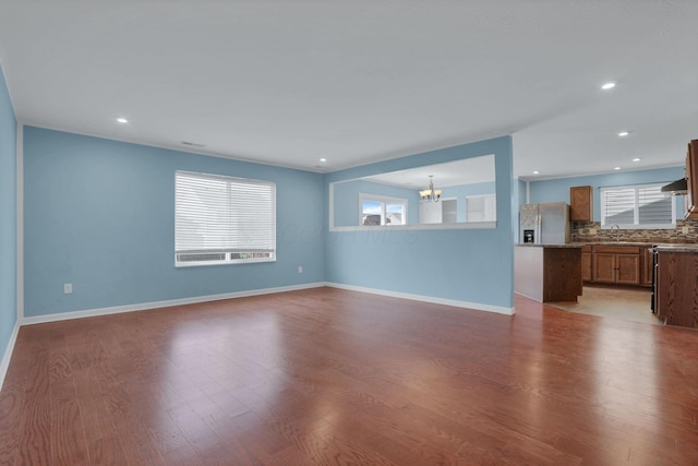7429 Willow Leaf Dr, Canal Winchester, OH 43110 - unfurnished living room featuring a chandelier, wood finished floors, recessed lighting, and baseboards