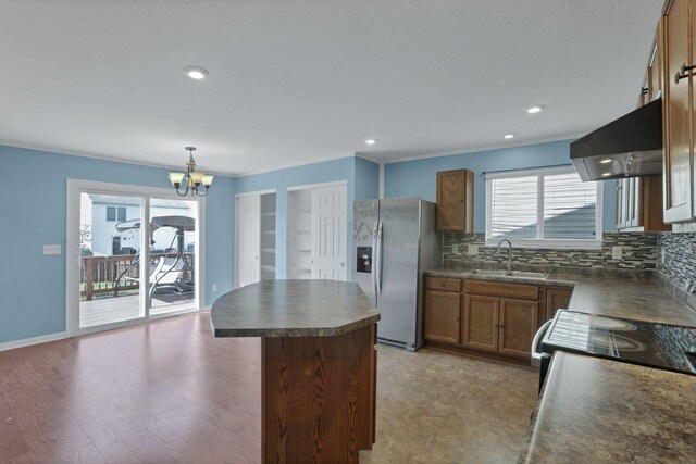 7429 Willow Leaf Dr, Canal Winchester, OH 43110 - kitchen with stainless steel fridge with ice dispenser, ventilation hood, a sink, dark countertops, and backsplash