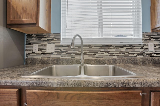 7429 Willow Leaf Dr, Canal Winchester, OH 43110 - kitchen view of a sink, backsplash, dark countertops, and brown cabinets