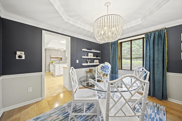 1009 Tall Tree Ct, Westerville, OH 43081 - dining space with a chandelier, light wood-style floors, a tray ceiling, and ornamental molding