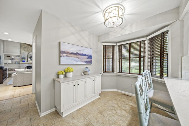 1009 Tall Tree Ct, Westerville, OH 43081 - office area with baseboards, stone tile flooring, a chandelier, and recessed lighting