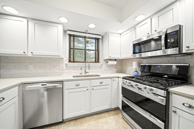 1009 Tall Tree Ct, Westerville, OH 43081 - kitchen featuring stainless steel appliances, a sink, white cabinetry, light countertops, and recessed lighting