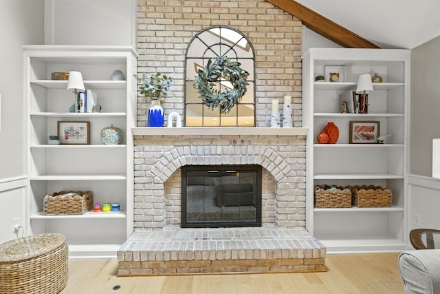 1009 Tall Tree Ct, Westerville, OH 43081 - living room featuring wood finished floors, a brick fireplace, and brick wall