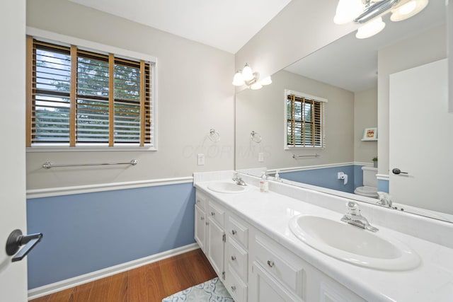 1009 Tall Tree Ct, Westerville, OH 43081 - full bath with double vanity, wood finished floors, baseboards, and toilet