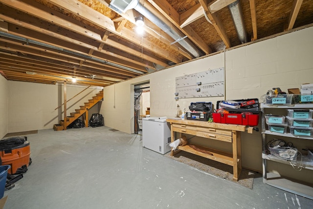 1009 Tall Tree Ct, Westerville, OH 43081 - unfinished basement featuring fridge, stairway, a workshop area, and concrete block wall